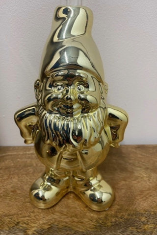 The Gold Gnome Single Stem Vase / Candlestick Holder against a white wall on a wooden surface.