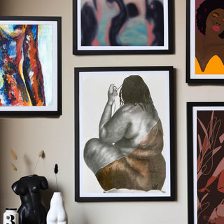 Image of a picture wall featuring hand drawn artworks by talented female artists. 