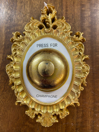 Image of the Press For Champagne Wall Ornament on a wooden surface