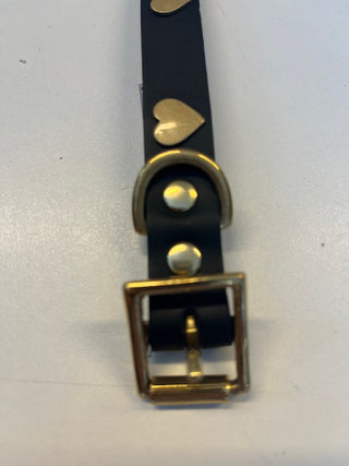 The buckle of the Black Leather Dog Collar with Hearts on a white background.