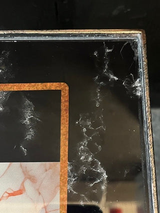 Close up of the corner of  Bronze Effect Chess Side Table.