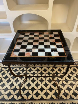 Image of the  Bronze Effect Chess Side Table  against white shelving on a black & white floor.