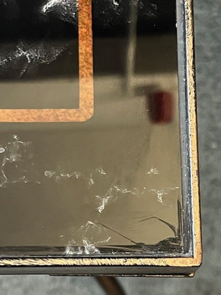 Close up of the corner of  Bronze Effect Chess Side Table.