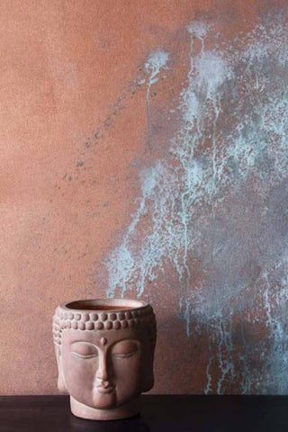 Image of Craig and Rose copper paint, painted on a wall with an Indian plant pot. 