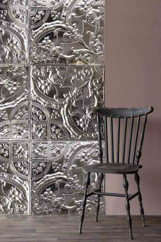 A lifestyle image of a room set featuring Rockett St George tin tiles with a metal traditional chair. 