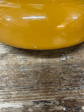 Close up of the base of the modern metal mustard lamp.