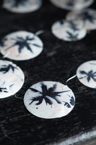 Close-up image of the Capiz Palm Print Shell Garland