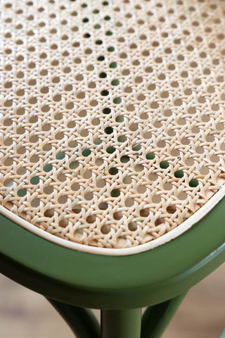 Close-up of the woven cane seat of the Chez Pitou Wood & Woven Cane Bar Stool in Green.