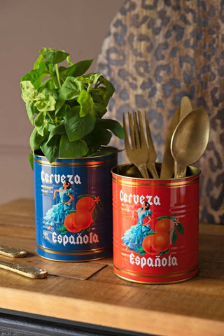 The Set Of 2 Flamenco & Orange Kitchen Storage Tins styled with a plant and some cutlery inside.