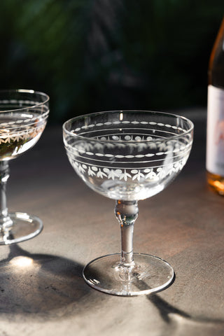 Lifestyle image of the Set Of 2 Vintage Etched Champagne Glasses