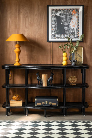 The Vintage-Inspired Black Rattan Console Table styled with various accessories on.