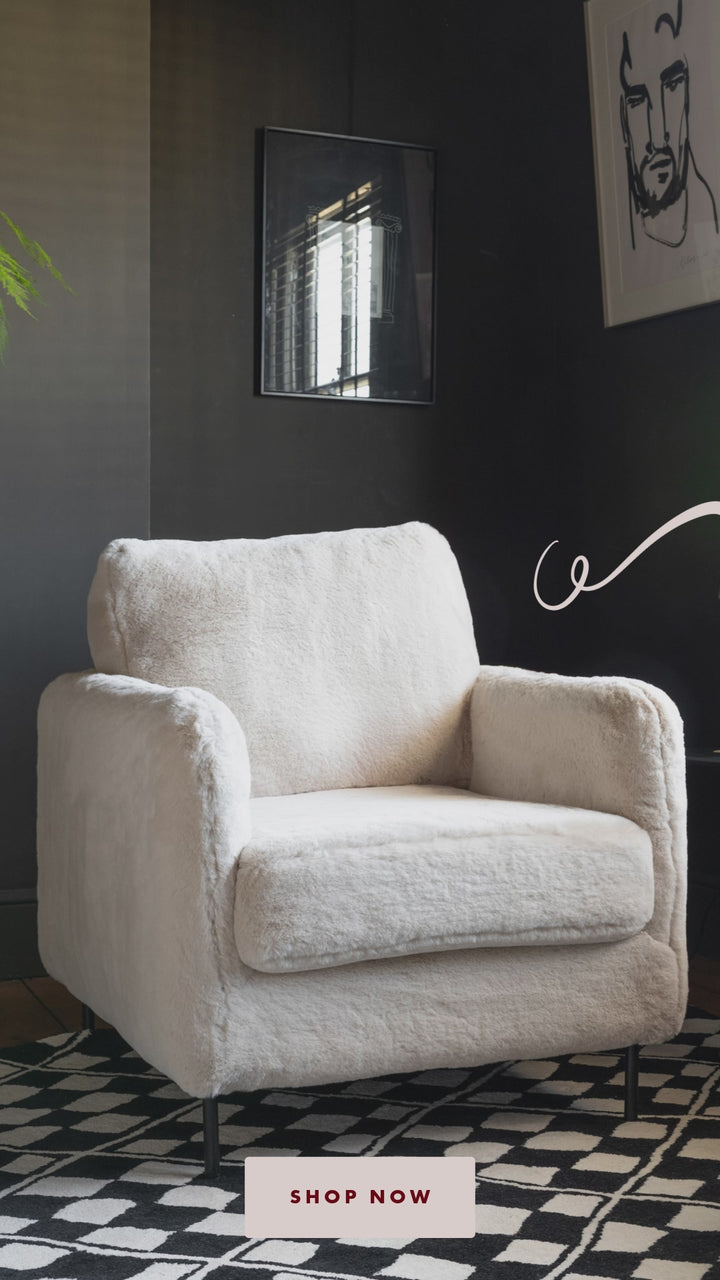 An image of an accent armchair in white faux fur