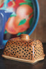 The lid being removed from the Painted Leopard Print Butter Dish.