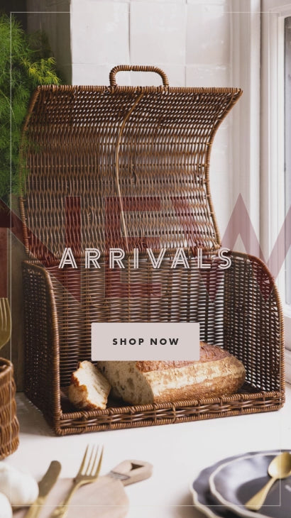 A rattan-style bread bin with a rustic loaf inside 
