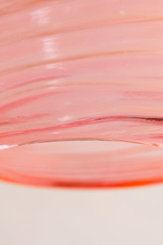 Close up detail image of the Swirled Glass Easyfit Ceiling Light Shade in Pink against a white wall