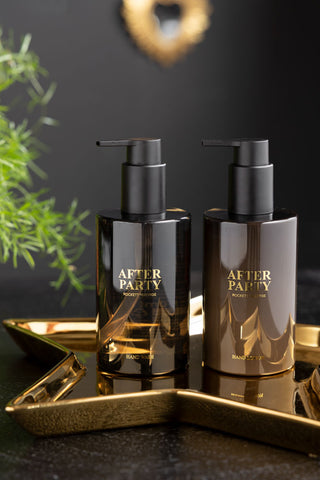 The After Party Hand Care Duo Gift Set displayed on a gold star tray with some greenery in the background.
