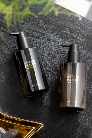 The After Party Hand Care Duo Gift Set displayed laying down on a dark wooden surface.
