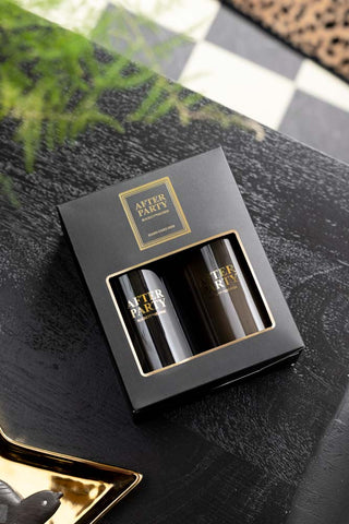 The After Party Hand Care Duo Gift Set in the box, displayed laying down on a dark wooden surface.