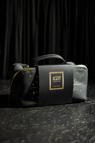 The After Party Makeup Bag Beauty Gift Set in its packaging, displayed on a dark leopard print surface.