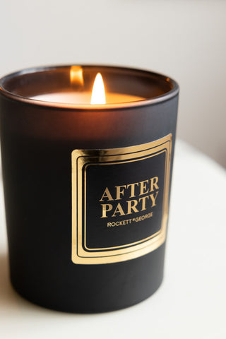 Close-up of the lit After Party Freesia & Amber Scented Candle.