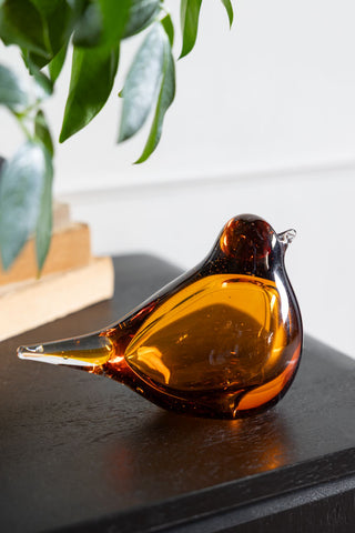 Lifestyle image of the Amber Glass Bird Ornament
