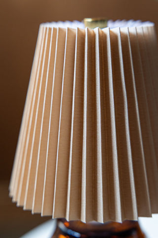 Close-up of the shade on the Amber Pleated Rechargeable Table Lamp.