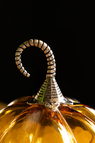 The gold top of the Small Amber Glass Pumpkin. 
