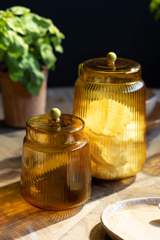 Image of the Amber Ribbed Glass Storage Jar - Tall with the smaller version