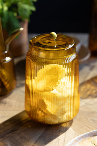 Lifestyle image of the Amber Ribbed Glass Storage Jar - Tall