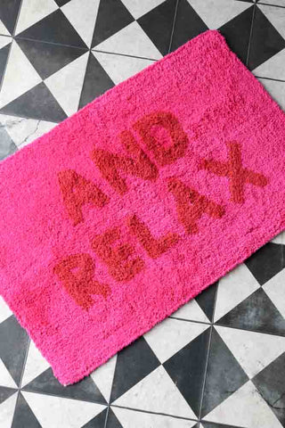 Lifestyle image of the And Relax Hot Pink Tufted Bath Mat