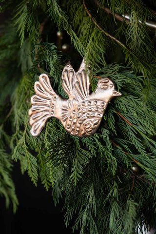 Close-up image of the Antique Gold Dove Christmas Tree Decoration on natural foliage