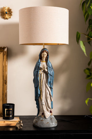 The Antique-Style Santa Maria Table Lamp styled on a dark surface.