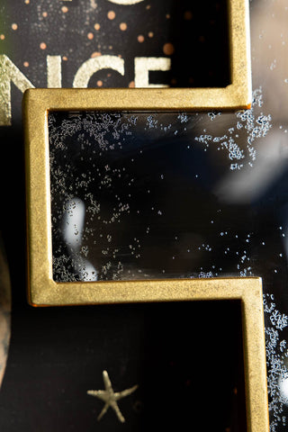 The foxed detailing on the Antique-style Gold Cross Wall Mirror. 