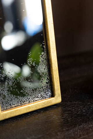 The corner of the Antique-style Gold Cross Wall Mirror. 