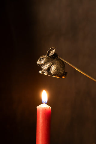 Lifestyle image of the Antiqued-Gold Rabbit Candle Snuffer