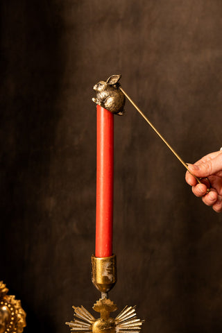 Image of the Antiqued-Gold Rabbit Candle Snuffer with a candle