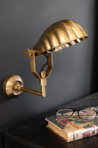 Image of the beautiful art deco shell wall light above a bedside table