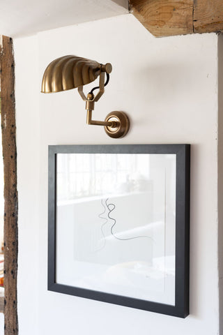 Wider image of the beautiful art deco shell wall light above an art print