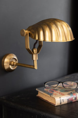 Closer image of the beautiful art deco shell wall light above a bedside table
