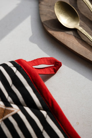 Close-up of the tab for hanging the Badge Patch Oven Gloves.