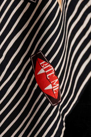 Close-up of the bite me motif on the Badge Patch Tea Towel.