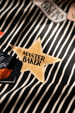 Close-up of the badges on the Badge Patch Tea Towel.