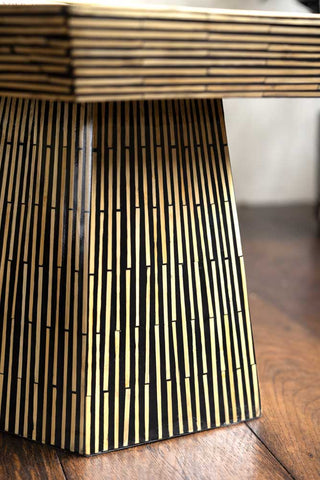 Close up of bamboo inlay hexagon coffee table base on wooden floor