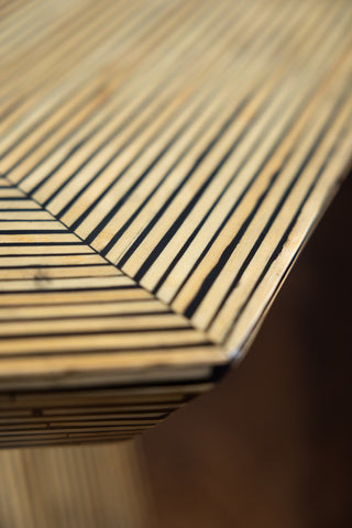 Closse up of bamboo inlay hexagon coffee table on wooden floor