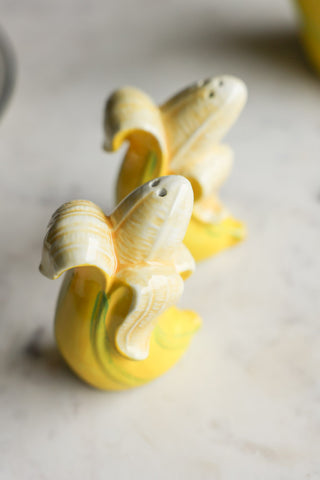 Banana Salt & Pepper Shakers displayed on a marble table.