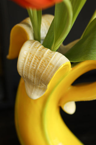 Detail image of the Banana Vase styled with tulips inside. 