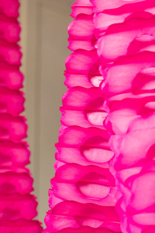 The detail of the honeycomb pattern on the Beautiful Handcrafted Classic Paper Garland in Hot Pink.