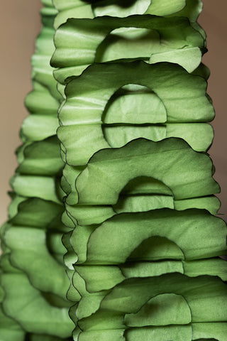 Close-up detail of the honeycomb-style pattern of the Beautiful Handcrafted Classic Paper Garland in Moss Green. 
