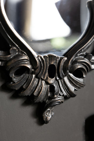 The bottom ornate frame detail on the Beautiful Ornate Black Wall Mirror. 