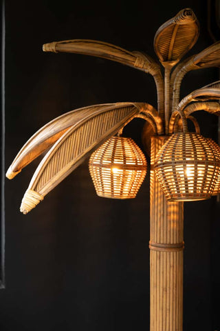 Lifestyle image of the Beautiful Rattan Palm Tree Floor Lamp.
